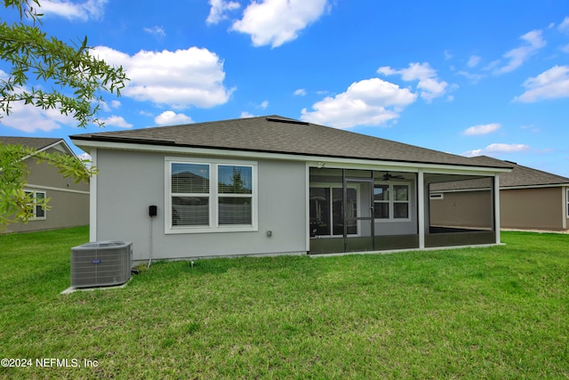 rear view of property with a yard, cooling unit, and a sunroom