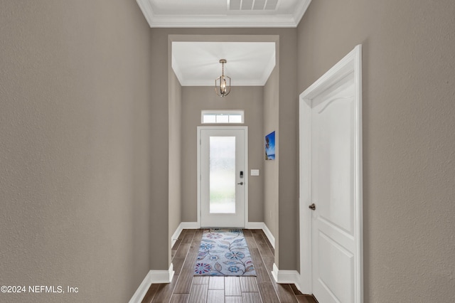 entryway with crown molding and a wealth of natural light