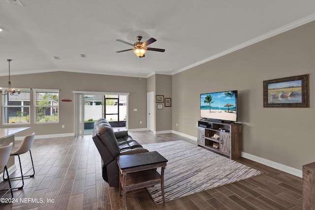 living room featuring vaulted ceiling, crown molding, and ceiling fan with notable chandelier