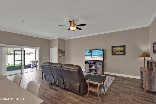 living room featuring ceiling fan and crown molding