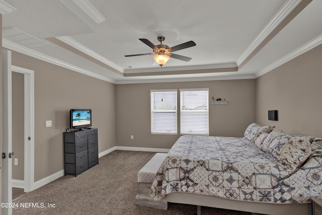 carpeted bedroom featuring a raised ceiling, ceiling fan, and ornamental molding