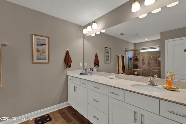 bathroom featuring vanity and an enclosed shower