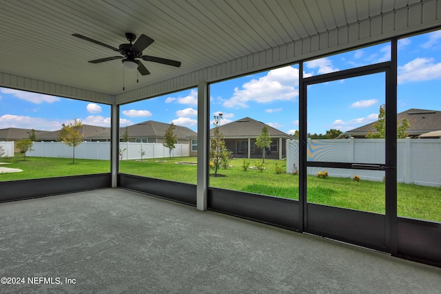 unfurnished sunroom with ceiling fan