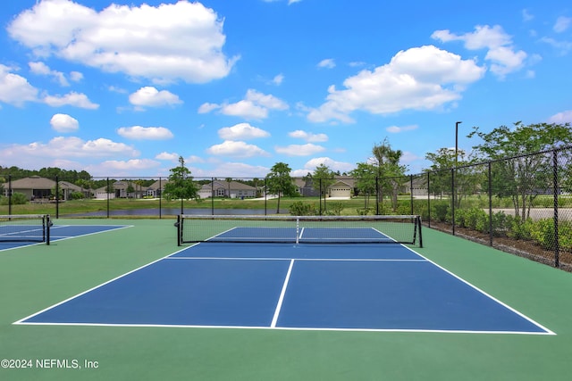 view of sport court with basketball hoop