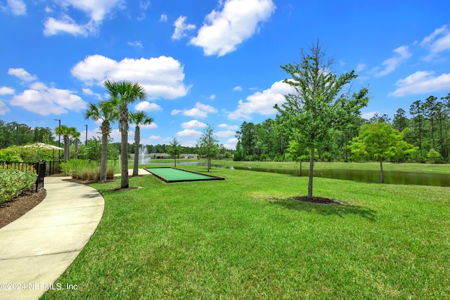 surrounding community featuring a water view and a yard