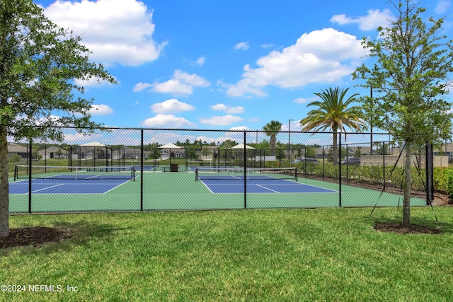 view of sport court featuring a yard