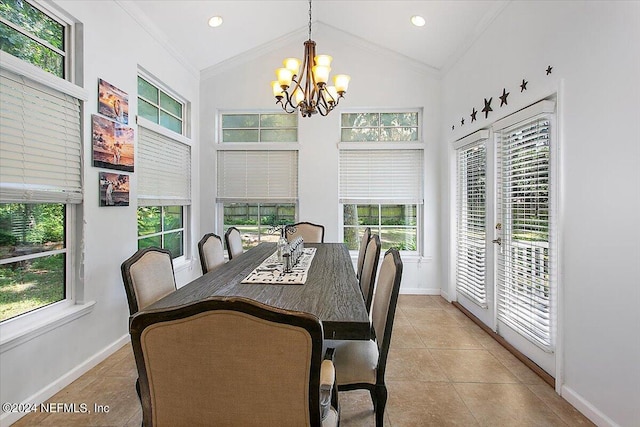 dining room with light tile patterned floors, an inviting chandelier, lofted ceiling, and crown molding