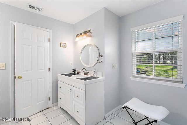 bathroom with tile patterned flooring and vanity