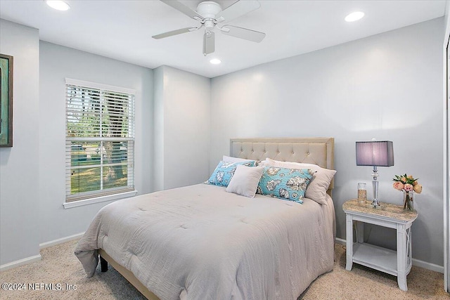 bedroom with ceiling fan and light colored carpet