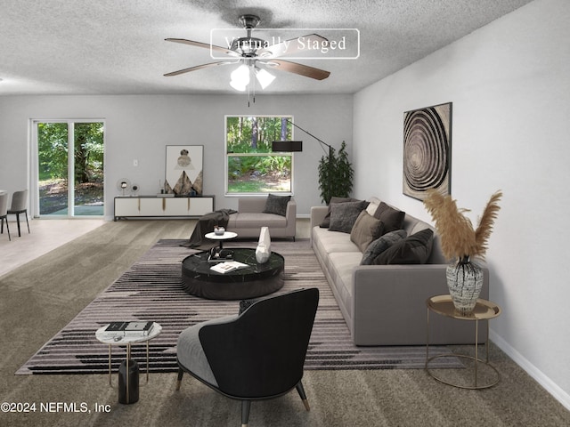 carpeted living room with ceiling fan and a textured ceiling