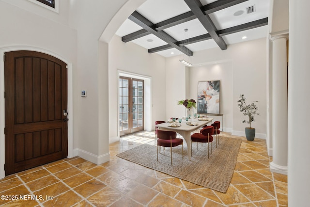 foyer entrance with arched walkways, baseboards, coffered ceiling, beamed ceiling, and french doors