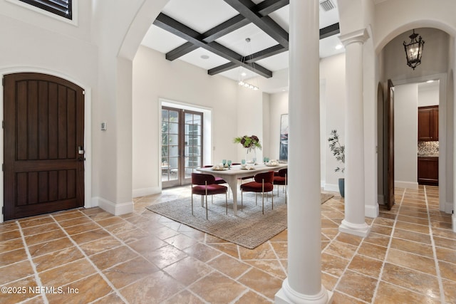 entryway featuring a high ceiling, beamed ceiling, coffered ceiling, and ornate columns