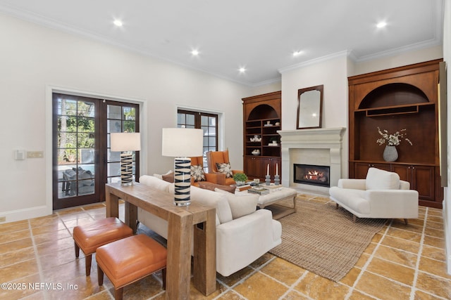 living room featuring french doors, recessed lighting, ornamental molding, a lit fireplace, and baseboards