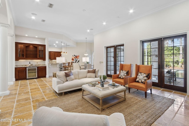 living area with wine cooler, recessed lighting, visible vents, french doors, and indoor wet bar