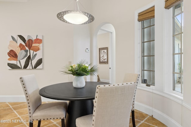 dining room with tile patterned flooring and baseboards