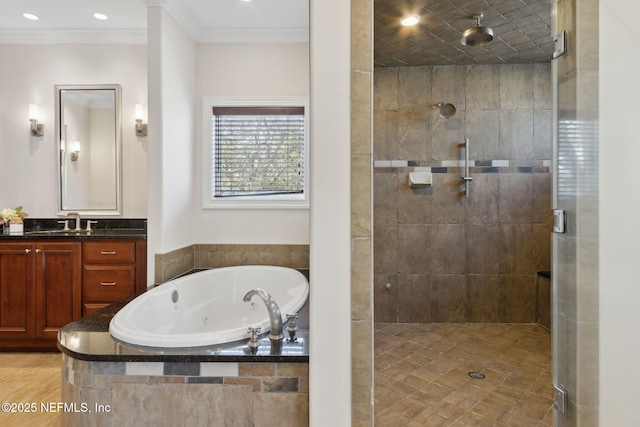 full bathroom featuring a whirlpool tub, ornamental molding, a shower stall, and vanity