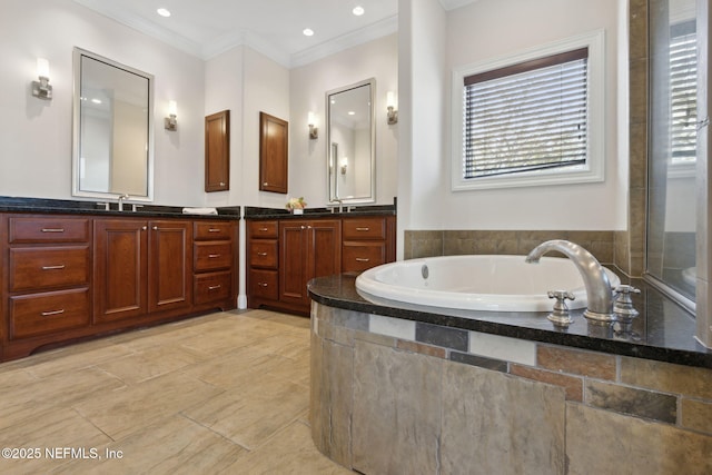 bathroom featuring ornamental molding, recessed lighting, a garden tub, and vanity