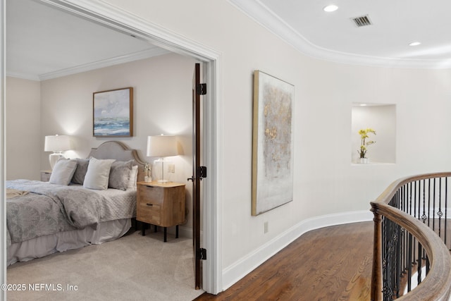 bedroom with baseboards, visible vents, ornamental molding, wood finished floors, and recessed lighting