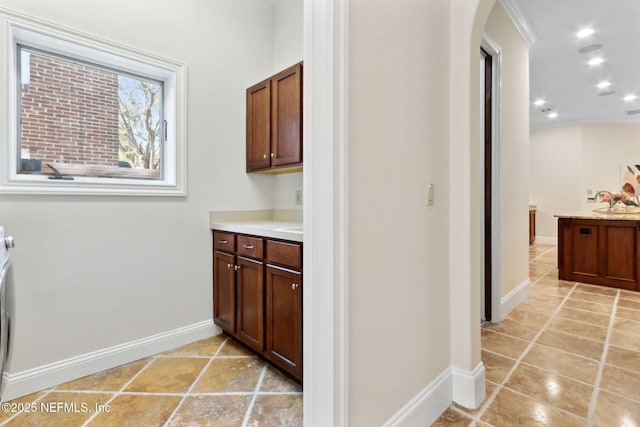 interior space with light tile patterned flooring, baseboards, a sink, and recessed lighting