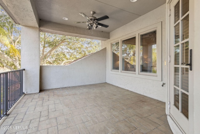 view of patio / terrace with ceiling fan and a balcony