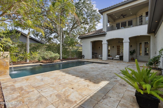 view of pool featuring ceiling fan, a patio area, fence, and a fenced in pool