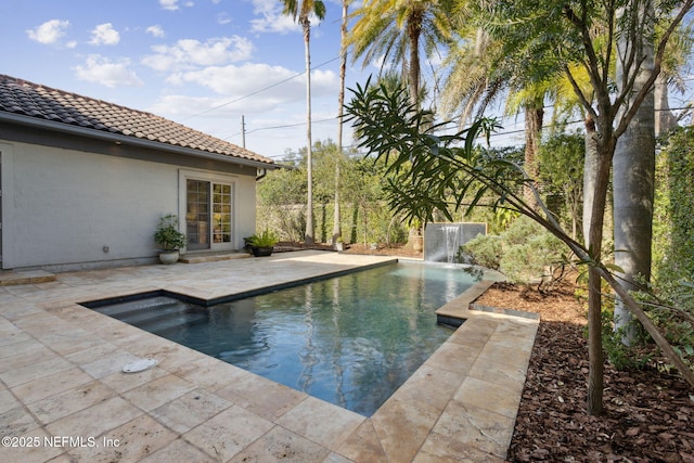 outdoor pool with a patio area