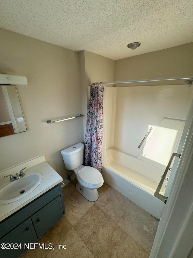 full bathroom featuring shower / bath combination with curtain, a textured ceiling, tile floors, toilet, and vanity