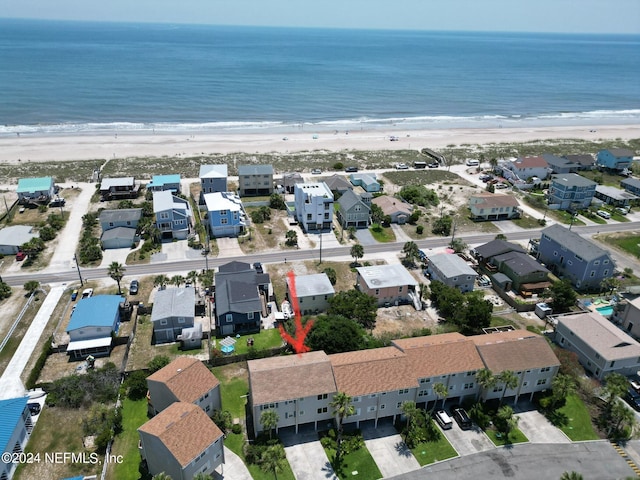 drone / aerial view featuring a water view and a view of the beach