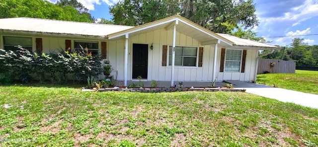 single story home with a front lawn and covered porch