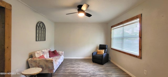 living area with ceiling fan and dark hardwood / wood-style flooring