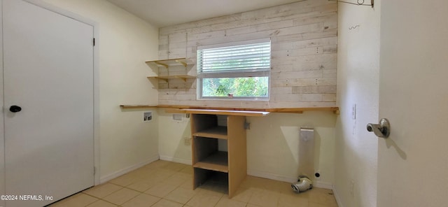 laundry area featuring hookup for a washing machine and light tile patterned flooring