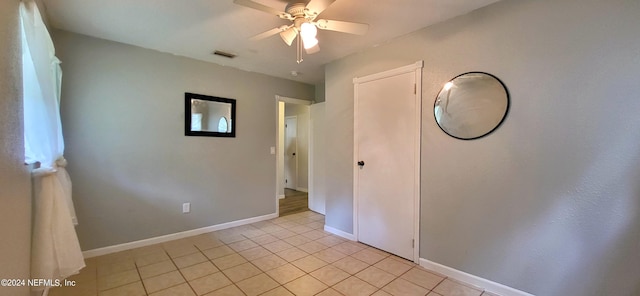 unfurnished bedroom featuring ceiling fan and light tile patterned floors