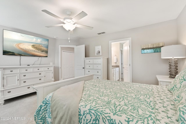 bedroom with carpet, a closet, ensuite bath, and ceiling fan