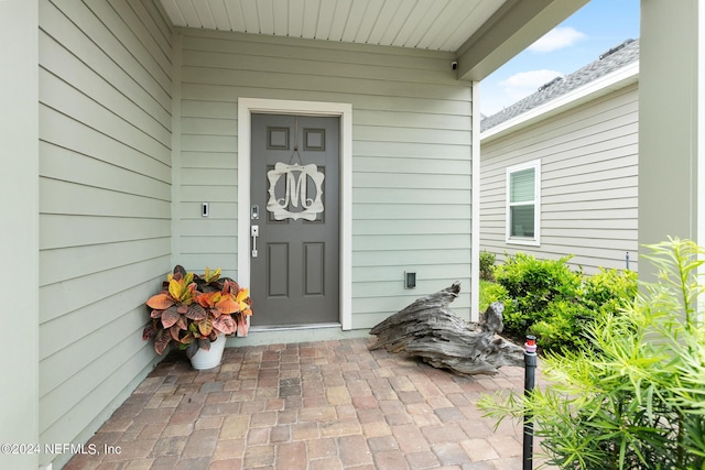 view of exterior entry with covered porch