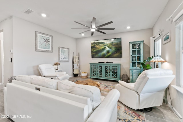 living room featuring ceiling fan and light wood-type flooring