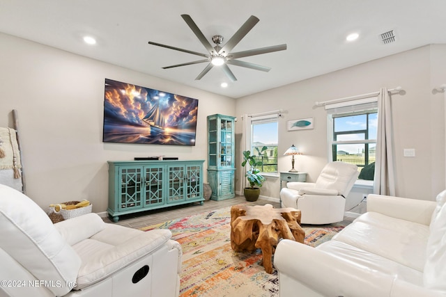 living room featuring ceiling fan and hardwood / wood-style flooring