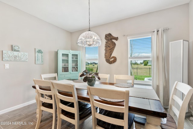 dining room with hardwood / wood-style floors and a notable chandelier