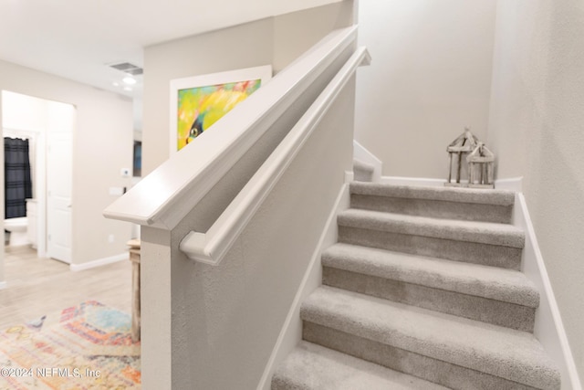 staircase featuring hardwood / wood-style floors