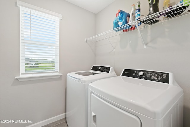 laundry room with tile patterned floors and washer and clothes dryer