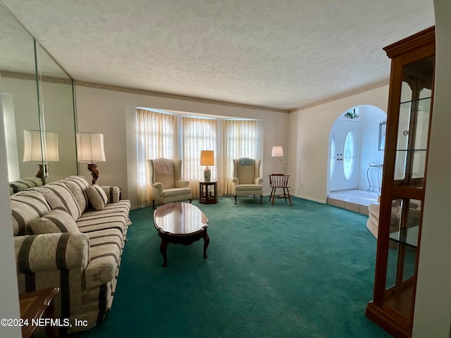 living room featuring carpet floors, ornamental molding, a wealth of natural light, and a textured ceiling