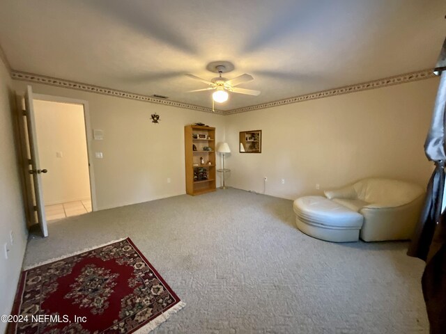 interior space featuring carpet floors and ceiling fan