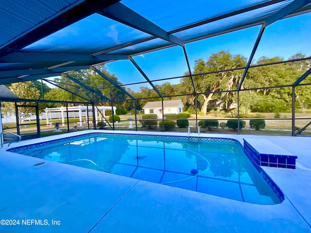 view of pool featuring glass enclosure