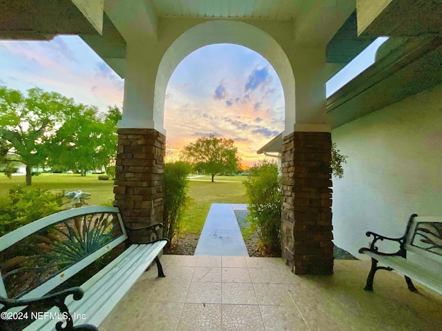 patio terrace at dusk with a lawn