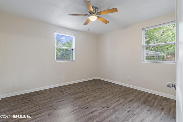 spare room with ceiling fan and dark wood-type flooring