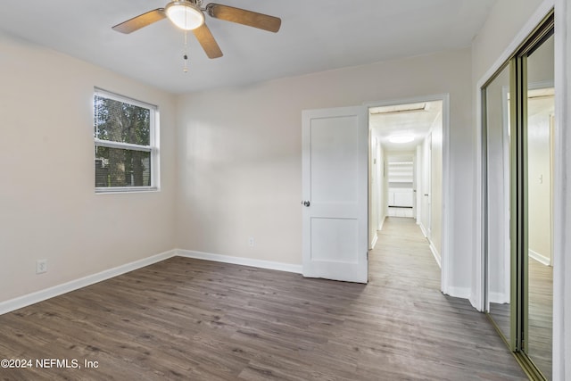 empty room featuring ceiling fan and dark hardwood / wood-style flooring