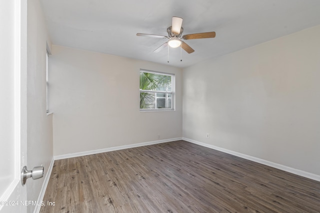 empty room with ceiling fan and dark hardwood / wood-style floors