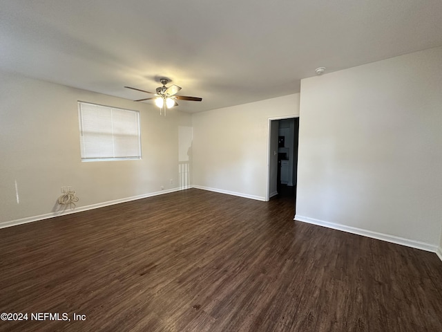 unfurnished room with dark hardwood / wood-style floors and ceiling fan