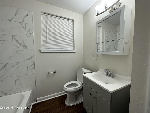 full bathroom with vanity, toilet, wood-type flooring, and tiled shower / bath