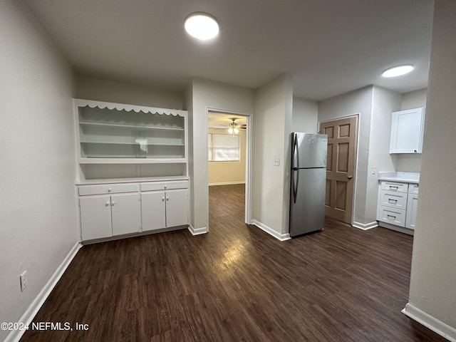 kitchen with white cabinets, dark hardwood / wood-style floors, stainless steel fridge, and ceiling fan