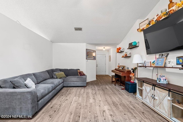 living room with hardwood / wood-style floors and a textured ceiling